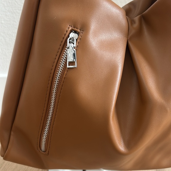 Tan bag with silver zipper in front of - Picture 3 of 5